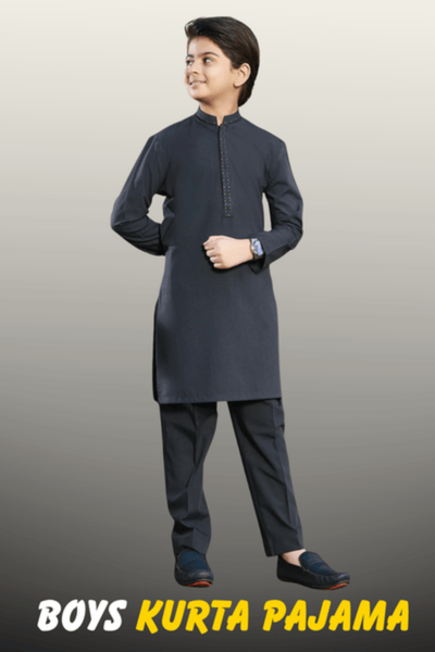 A young boy wearing a charcoal grey ethnic kurta pajama with a buttoned placket and mandarin collar from Nazz Collections.