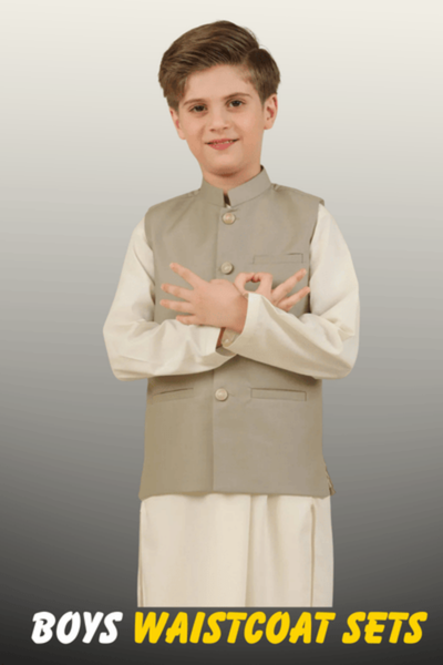A young boy wearing an off-white kurta pajama paired with a light grey formal waistcoat from the Nazz Collections Boys festive range.