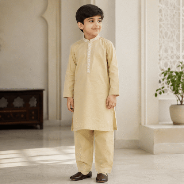 Pakistani boy wearing a cream kurta trouser set with embroidered collar and placket from Nazzcollections.com